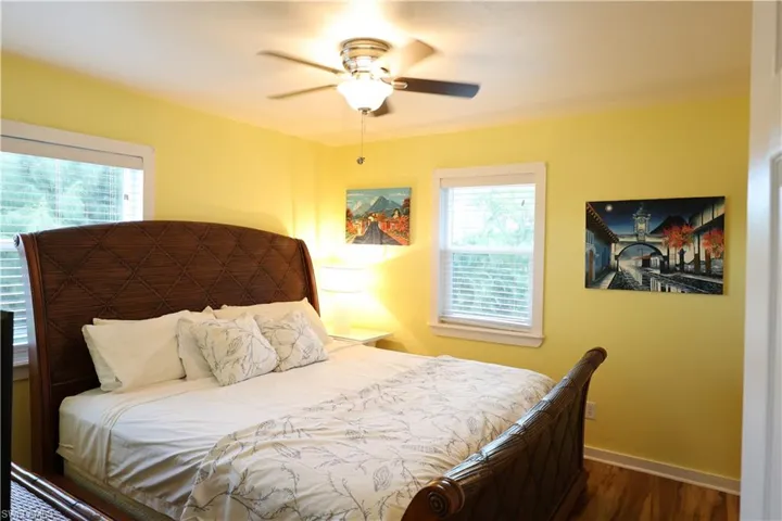 Bedroom with wood finished floors and a ceiling fan