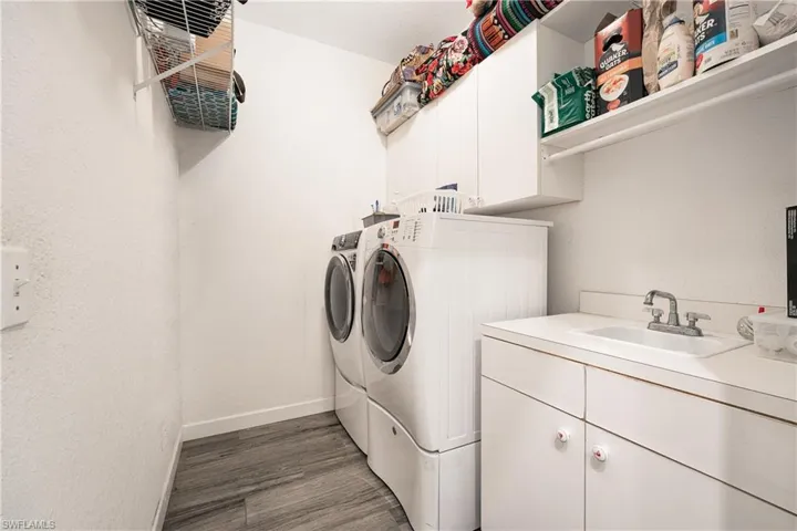 Large Laundry Room with cabinets for storage & sink