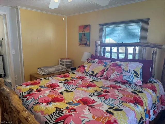 Bedroom featuring crown molding and ceiling fan