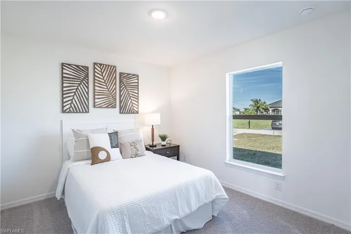 Carpeted bedroom featuring baseboards