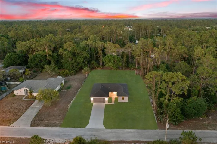Aerial view at dusk with a wooded view