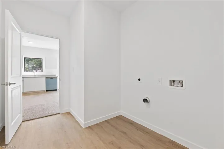 Laundry room featuring washer hookup, laundry area, electric dryer hookup, baseboards, and light wood finished floors