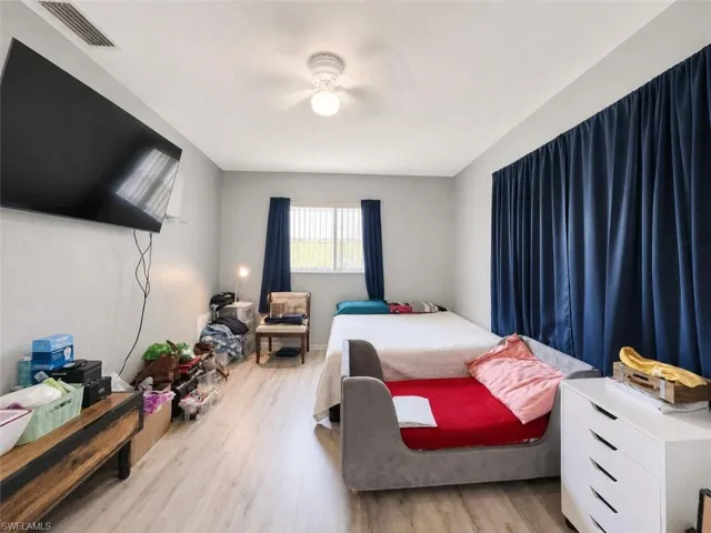 Light gray walls with wood-finish flooring