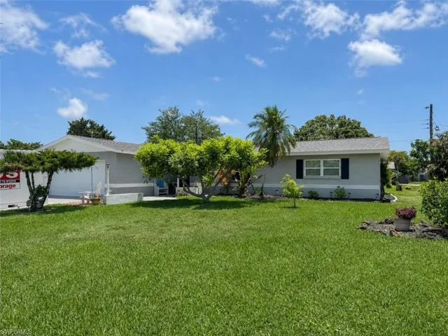 Single-story residence featuring a light gray exterior with a white trim and a shingle roof
