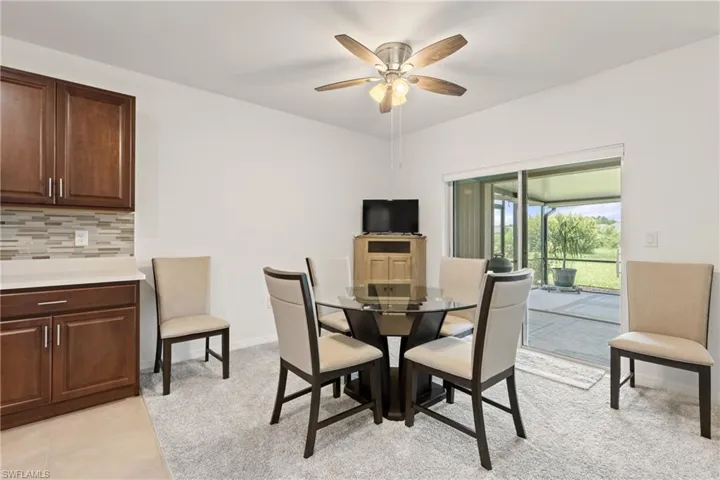Tiled dining room with ceiling fan