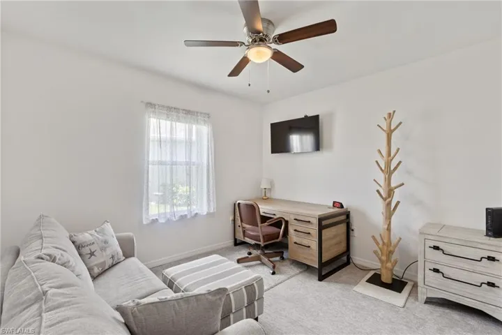 Carpeted bedroom with ceiling fan