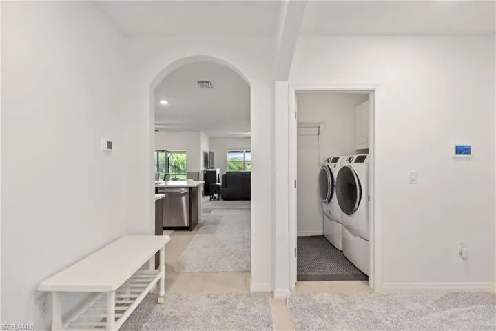 Washroom featuring light tile patterned floors and washer and dryer