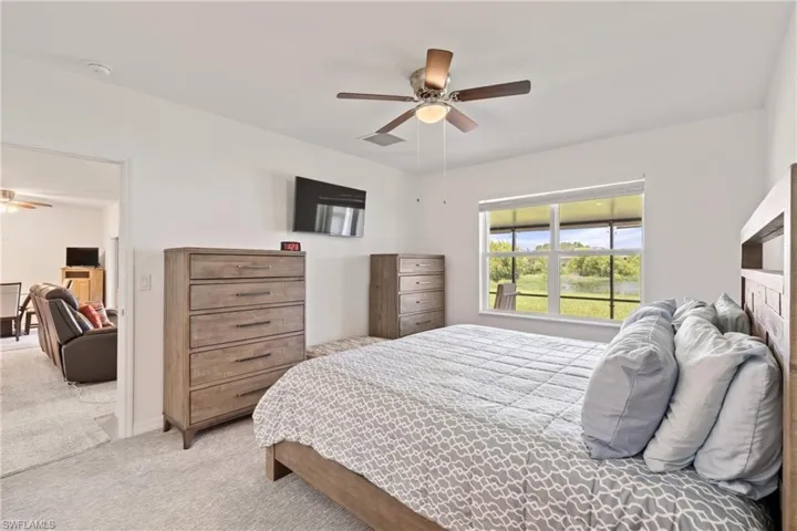 Carpeted bedroom with ceiling fan
