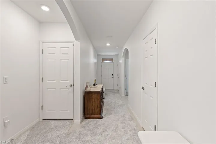 Hall featuring light colored carpet