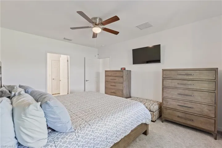 Bedroom featuring ceiling fan and carpet floors