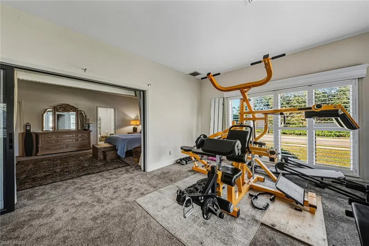 Workout area featuring carpet flooring and baseboards