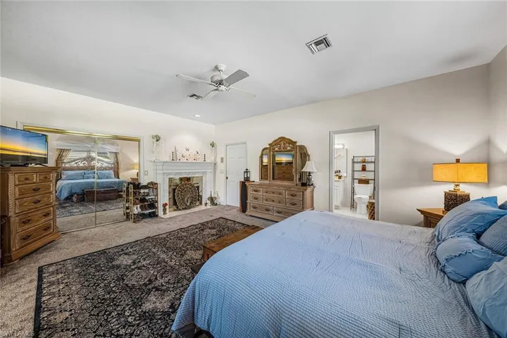 2nd Primary Bedroom with carpet floors, ceiling fan, a closet, and a high end fireplace