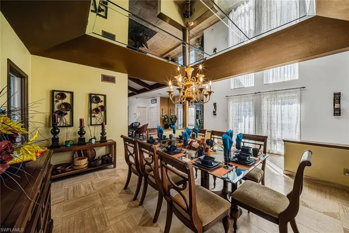Dining room featuring a chandelier and a high ceiling