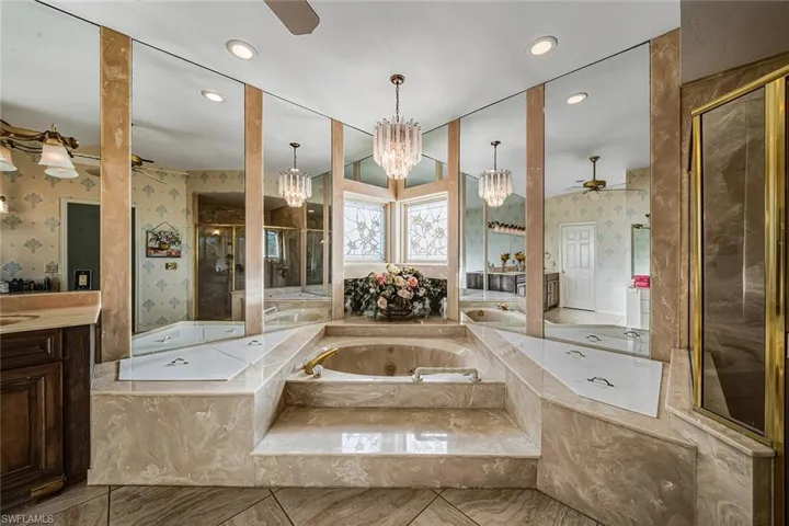 Full bathroom featuring a ceiling fan, a tub with jets, wallpapered walls, vanity, and recessed lighting
