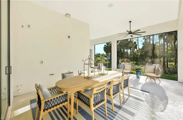 View of patio featuring outdoor dining area and a ceiling fan