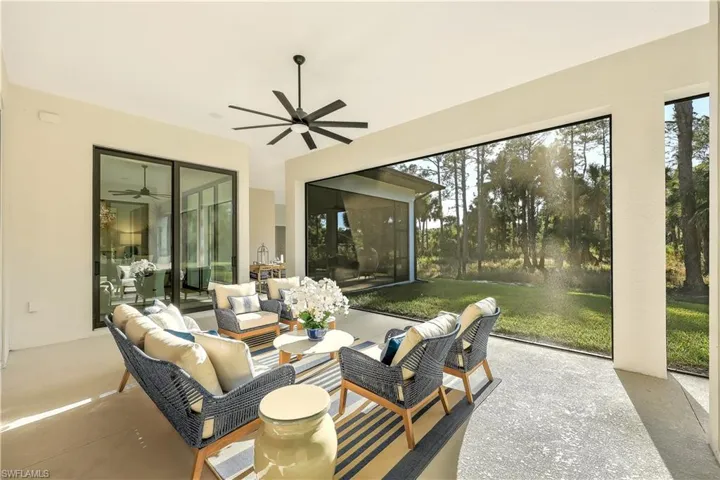 Sunroom / solarium featuring outdoor seating, a ceiling fan, and a patio