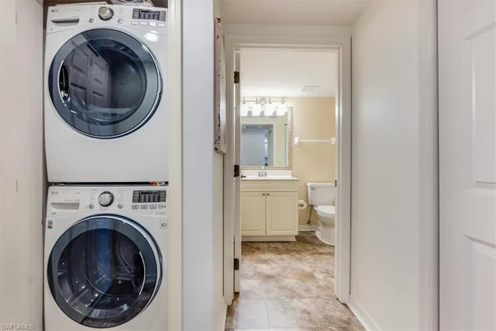 Full size stacked washer and dryer in closed door closet