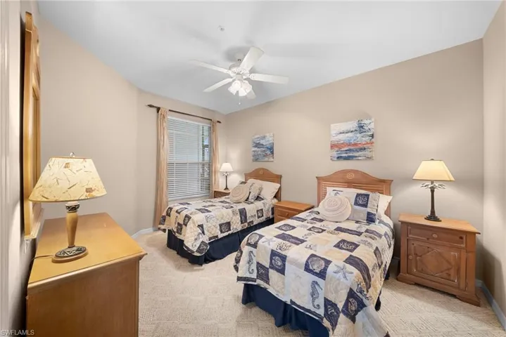 Bedroom featuring light carpet and ceiling fan