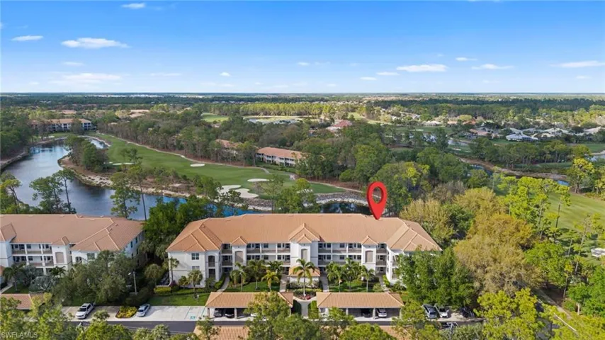 Bird's eye view of a golf course and a nearby body of water