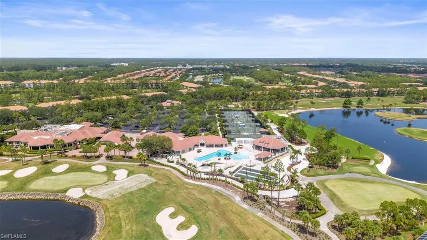 Aerial view of property's location with a nearby body of water, a local golf course, and nearby suburban area