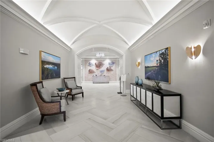 Hall featuring a barrel ceiling and baseboards