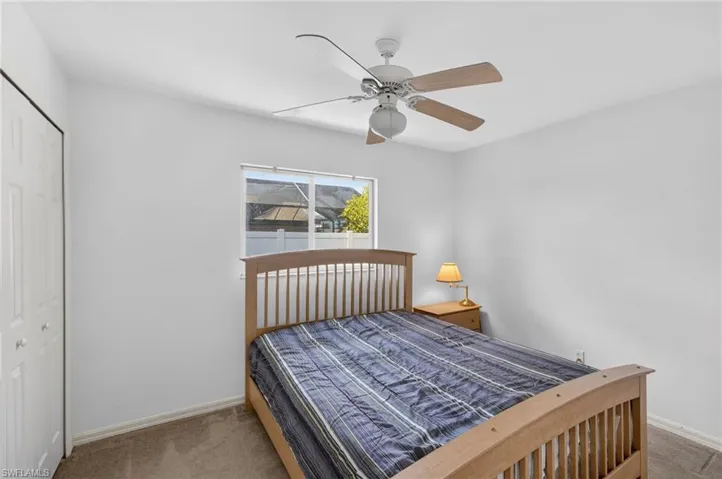 Bedroom with carpet flooring, a closet, and ceiling fan