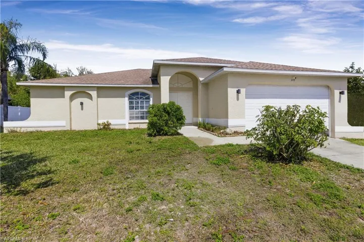 View of front of house with stucco siding, an attached garage, a front lawn, concrete driveway, and roof with shingles