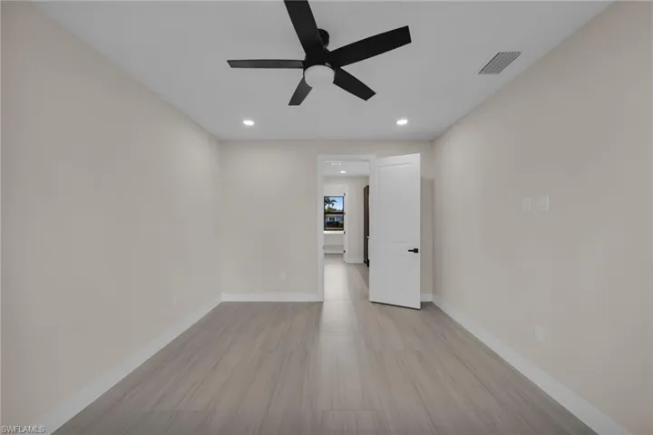 Empty room with ceiling fan, recessed lighting, and light wood-style floors
