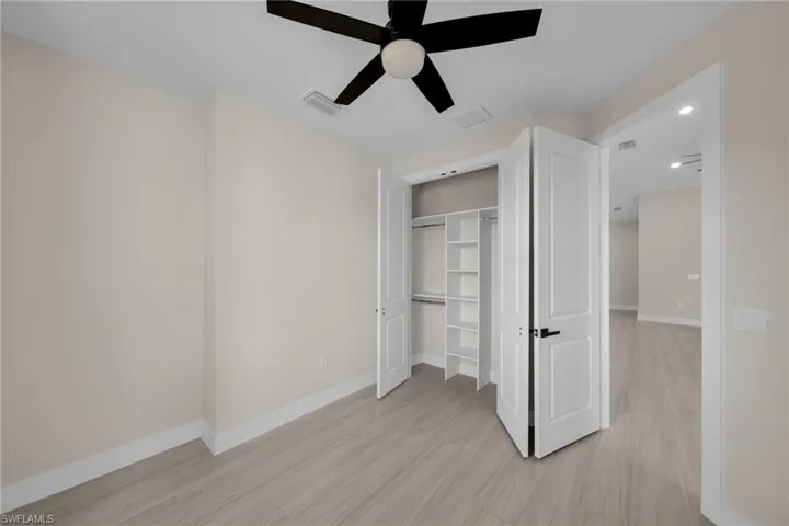 Unfurnished bedroom featuring a ceiling fan, a closet, and recessed lighting