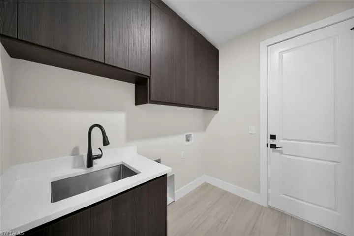 Laundry room with washer hookup and cabinet space