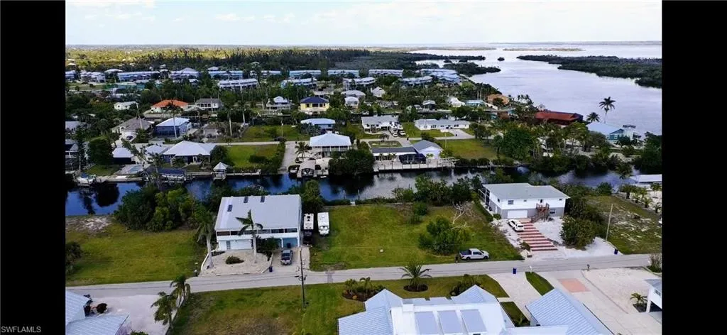 Drone / aerial view featuring Charlotte Harbor in the distance.