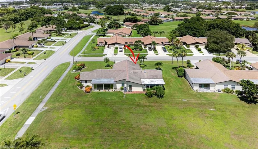 Aerial view of residential area featuring a golf course