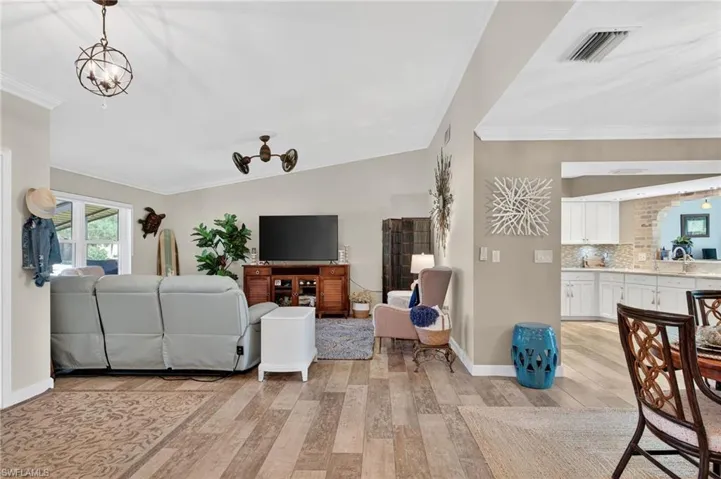 Living room featuring ornamental molding and light wood-style floors