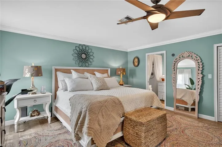 Bedroom with ornamental molding and a ceiling fan