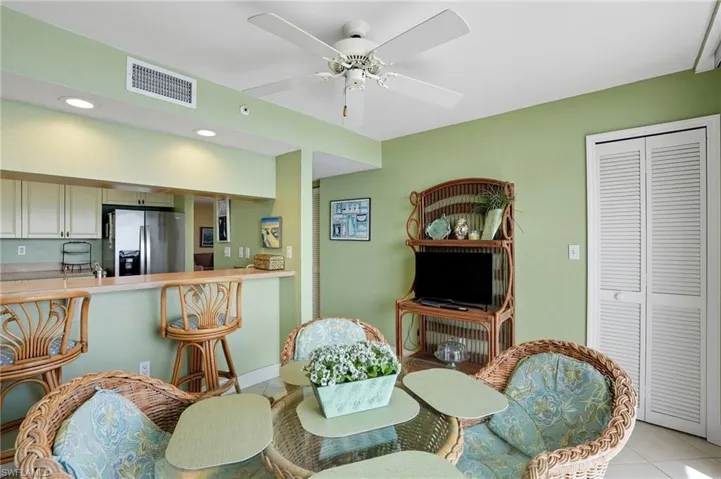 Dining room featuring light tile patterned flooring, recessed lighting, and a ceiling fan - Virtually Edited Image