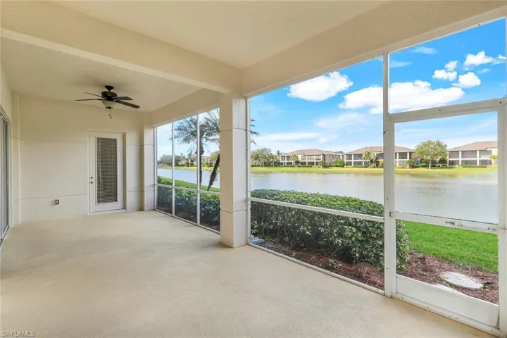 Unfurnished sunroom with a water view and ceiling fan