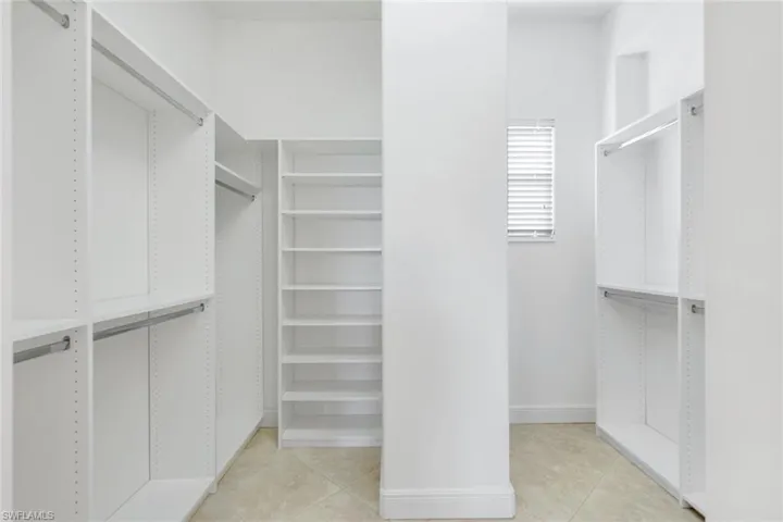 Walk in closet featuring light tile patterned floors