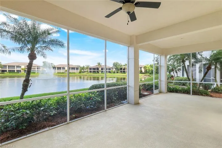 Unfurnished sunroom with a water view and ceiling fan