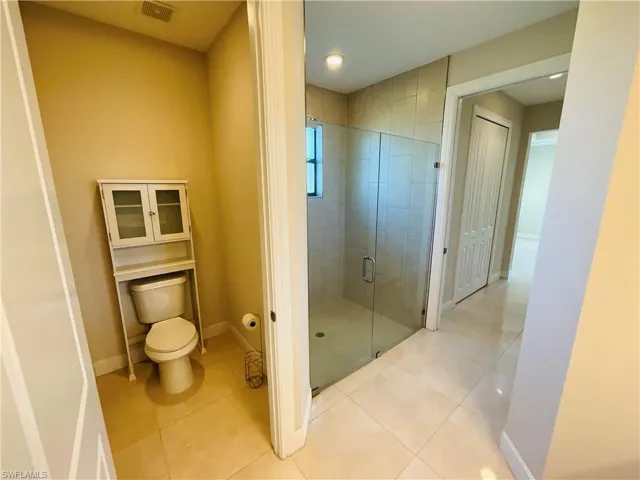 Full bath with a stall shower and tile patterned floors