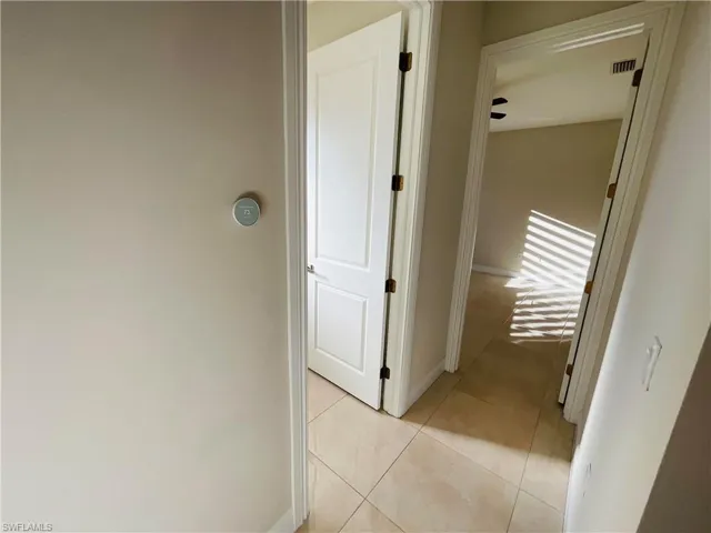 Corridor featuring light tile patterned floors