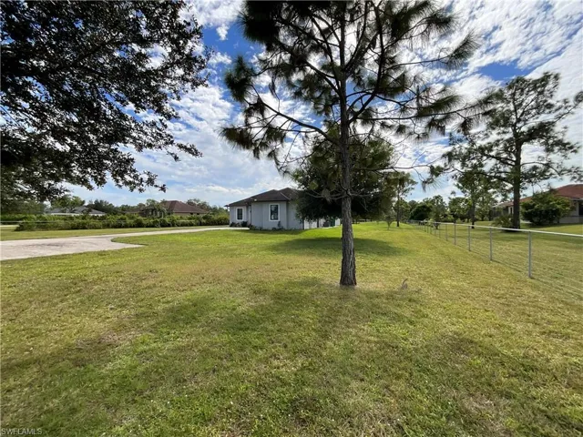 View of yard featuring concrete driveway