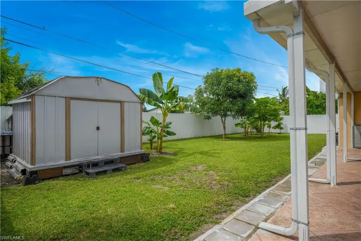 View of yard featuring a storage unit