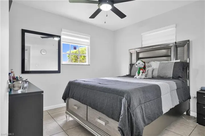 Tiled bedroom with ceiling fan