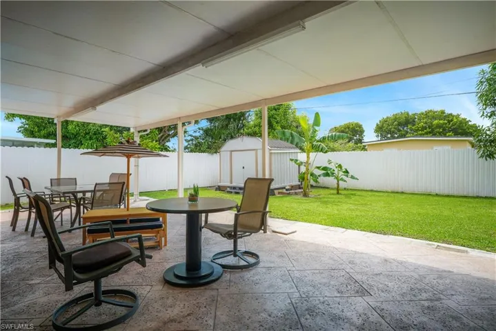 View of patio with a storage shed