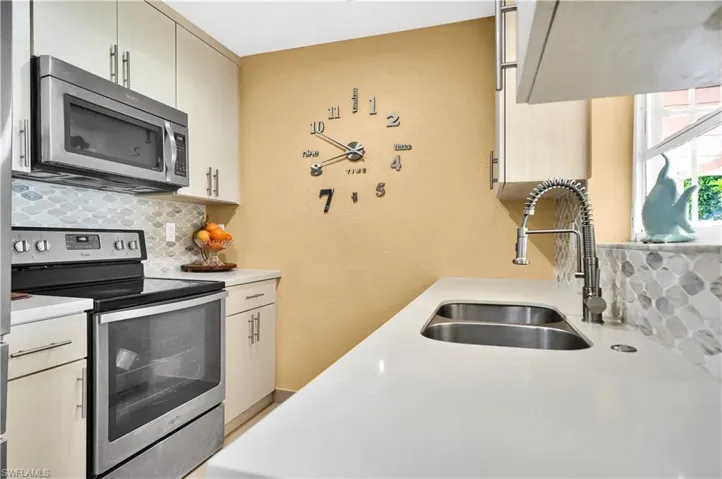 Kitchen with stainless steel appliances, backsplash, and sink