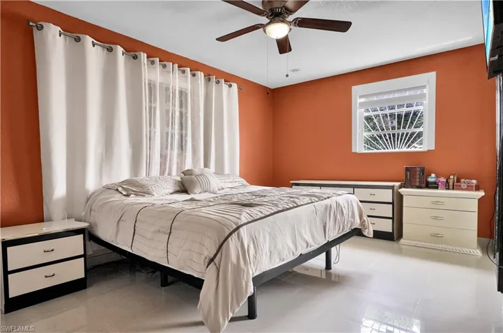 Tiled bedroom with ceiling fan