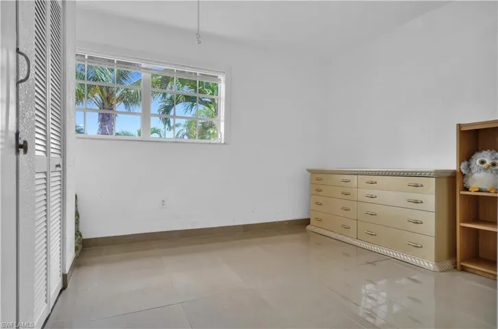 Unfurnished bedroom with light tile patterned flooring
