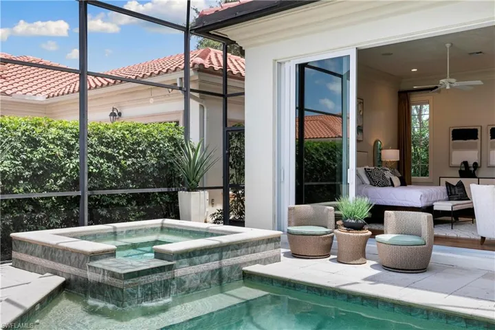 View of pool with an in ground hot tub, outdoor lounge area, and ceiling fan