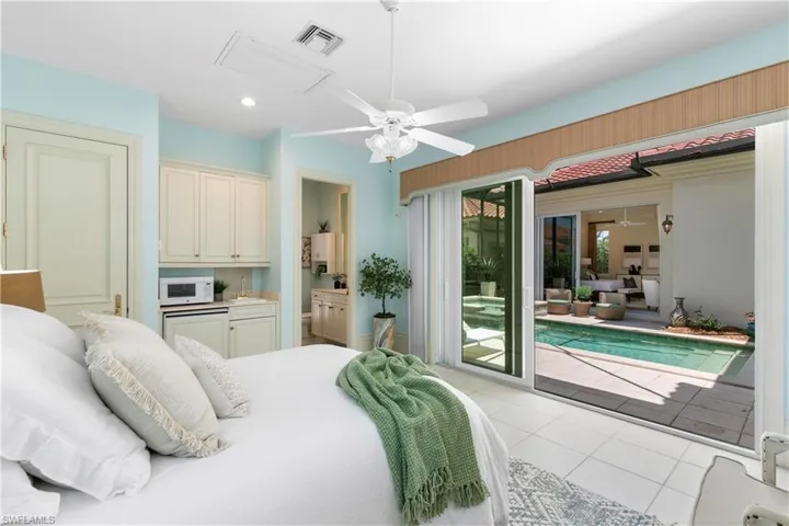 Bedroom with ceiling fan, access to exterior, and light tile floors