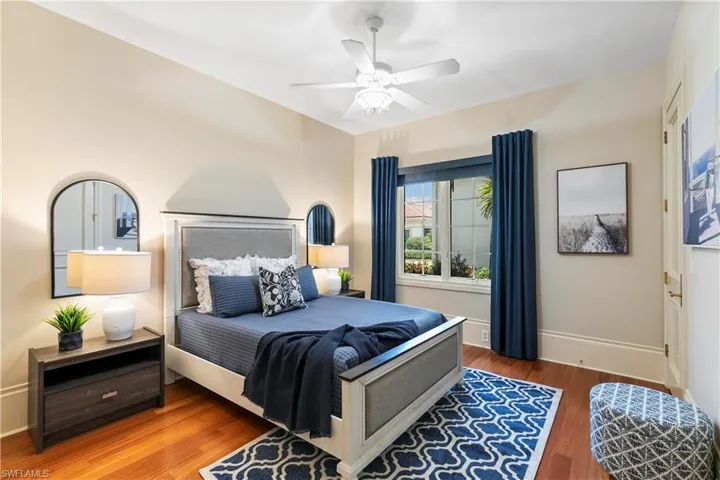 Bedroom with ceiling fan and wood-type flooring